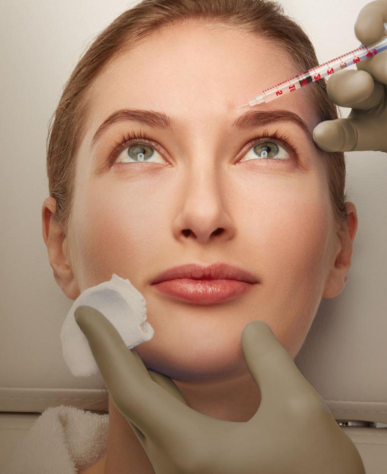 Close-up of a woman's face receiving an injectionin her forehead