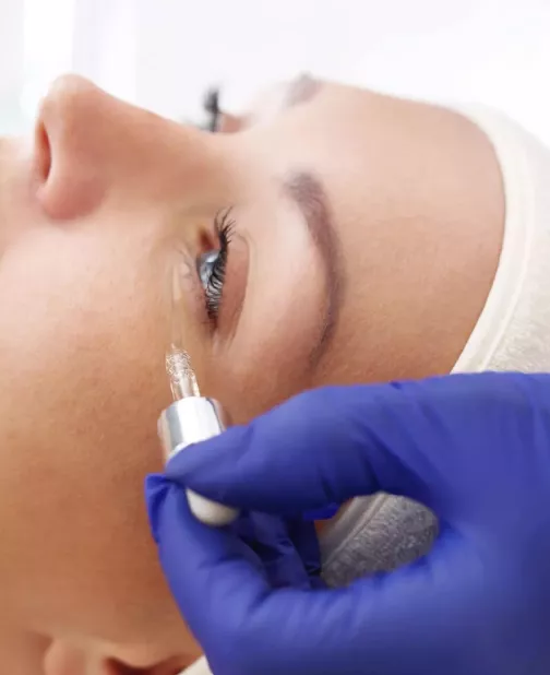 Portrait of a woman having serum applied to her eyes